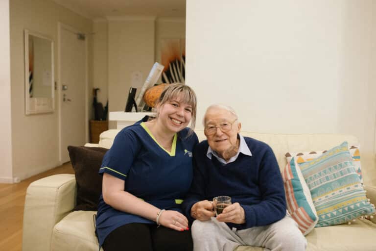 in-home carer and a client smiling