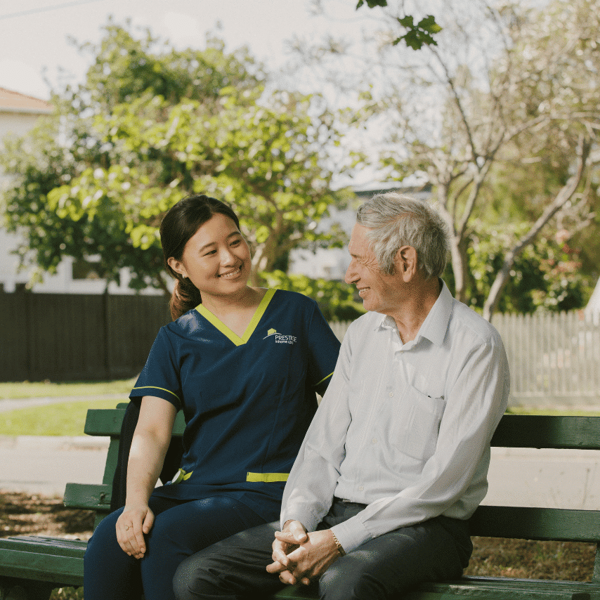 Prestige client sitting outside with his carer