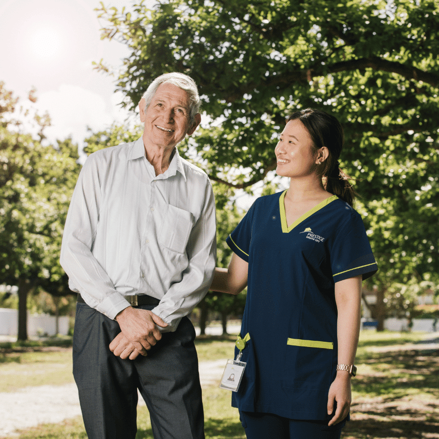 Prestige client on a walk with carer outside